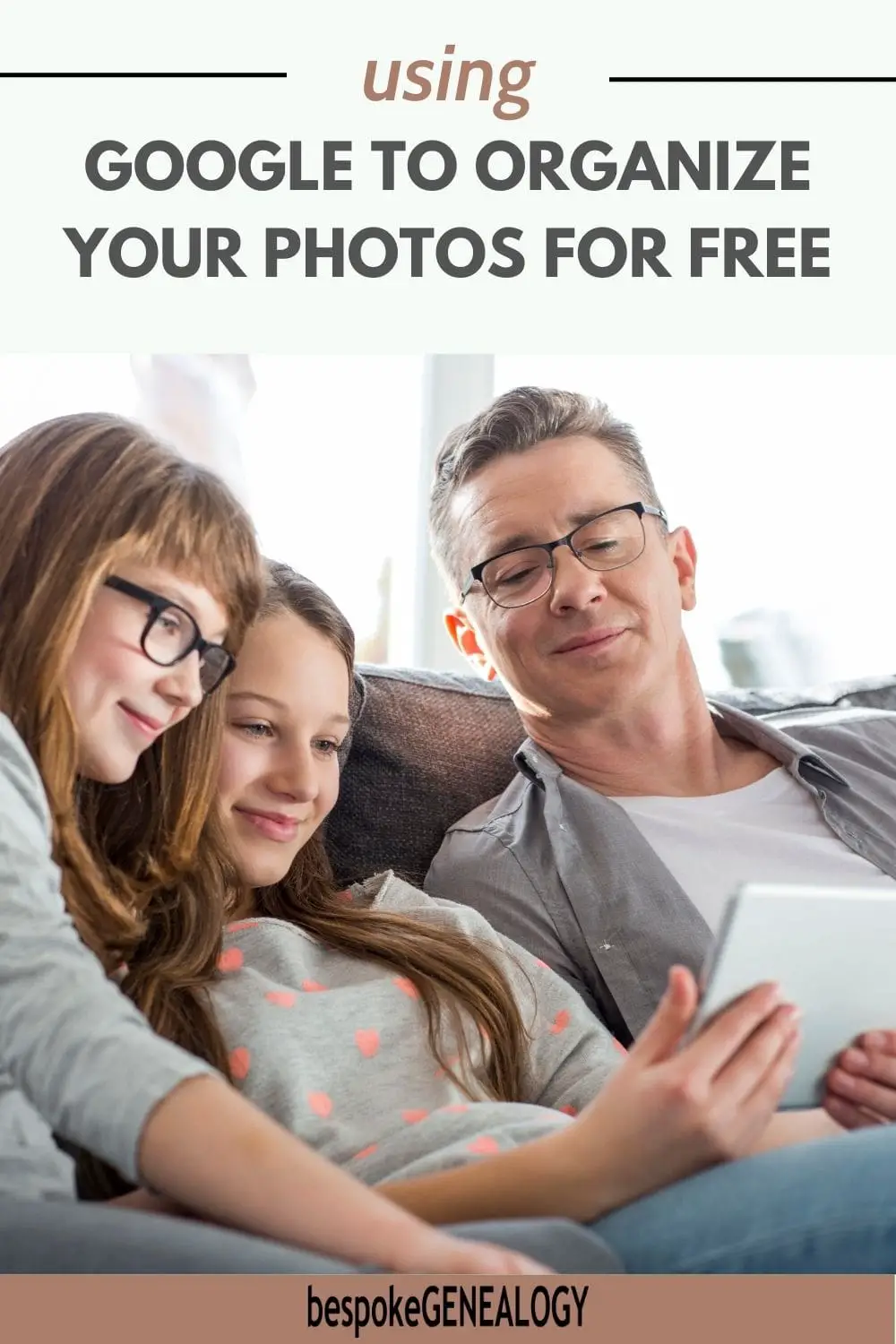 Using Google to organize your photos for free. Picture of a man on a sofa with his two daughters looking at a tablet together